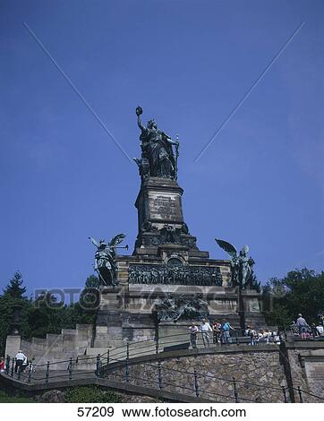 Low angle view of statues at monument, Niederwalddenkmal, Niederwald Landscape Park, Rudesheim am Rhein, Hesse, Germany View Large Photo Image Stock Photo - Low angle view of statues at monument, Niederwalddenkmal, Niederwald Landscape Park, Rudesheim am Rhein, Hesse, Germany . Fotosearch