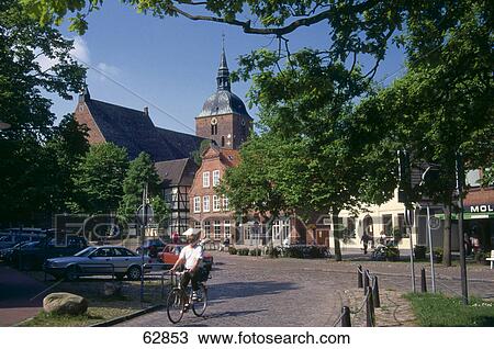 Man cycling on road in town View Large Photo Image Stock Image - Man cycling on road in town . Fotosearch