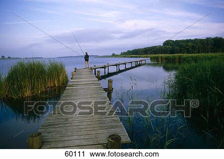 Man standing on footbridge View Large Photo Image Stock Image - Man standing on footbridge . Fotosearch