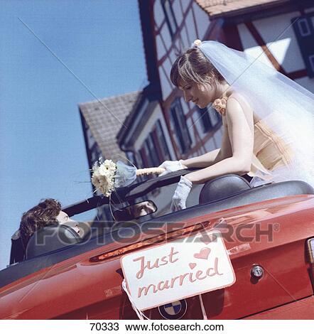 Newlywed couple sitting in car View Large Photo Image Stock Image - Newlywed couple sitting in car . Fotosearch