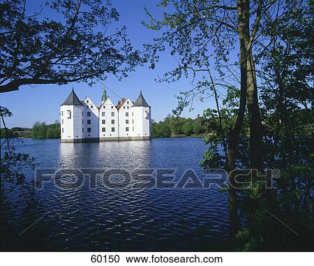 Stock Image - Palace in lake at dusk, Glücksburg, Schleswig-Holstein, Germany . Fotosearch