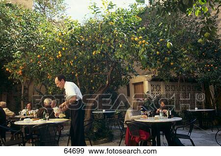 Stock Photo - People at cafe in courtyard . Fotosearch