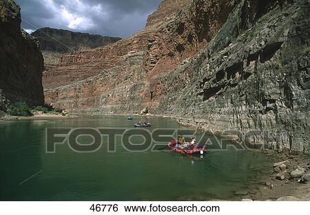 Stock Photograph - People paddling inflatable boats in river, Colorado River, Arizona, USA . Fotosearch