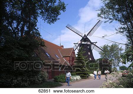 People walking besides traditional windmill, Lemkenhafen, Fehmarn Island, Schleswig-Holstein, Germany View Large Photo Image Stock Image - People walking besides traditional windmill, Lemkenhafen, Fehmarn Island, Schleswig-Holstein, Germany . Fotosearch