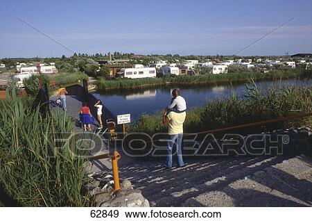 Stock Photo - Rear view of man carrying his child on his shoulders . Fotosearch