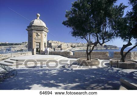 Rear view of two people standing at harbor, Vedette, Senglea, Malta View Large Photo Image Picture - Rear view of two people standing at harbor, Vedette, Senglea, Malta . Fotosearch
