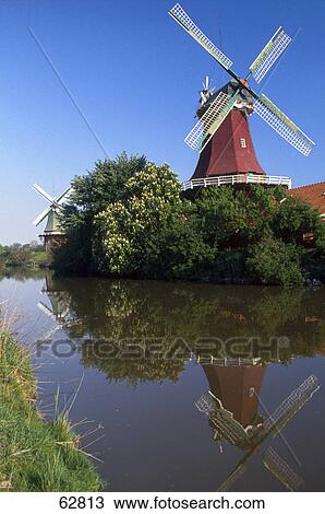 Reflection of traditional windmills in canal, Greetsiel, East Frisia, Lower Saxony, Germany View Large Photo Image Stock Image - Reflection of traditional windmills in canal, Greetsiel, East Frisia, Lower Saxony, Germany . Fotosearch