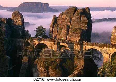 Stock Photograph - Rock formations around bridge on landscape, Bastei Bridge, Schweiz National Park, Saxony, Germany . Fotosearch
