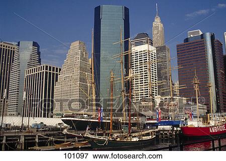 Sailing ships at port with skyscrapers in background, South Street Seaport, Manhattan, New York City, New York State, USA View Large Photo Image Stock Photo - Sailing ships at port with skyscrapers in background, South Street Seaport, Manhattan, New York City, New York State, USA . Fotosearch