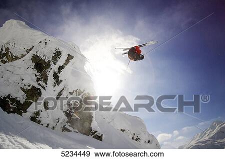 Stock Photo - Skier doing a jump . Fotosearch