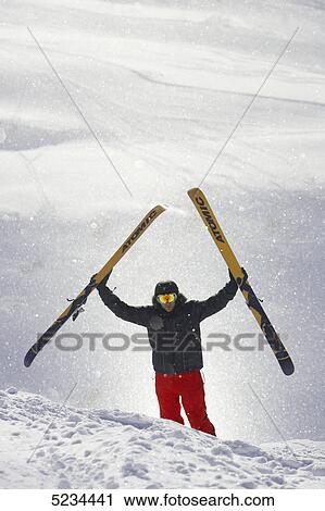 Stock Image - Skier standing at mountain . Fotosearch