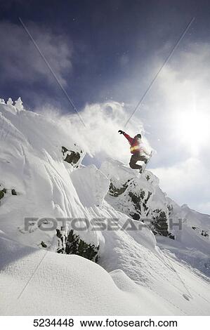 Stock Photo - Snowboarder jumping . Fotosearch