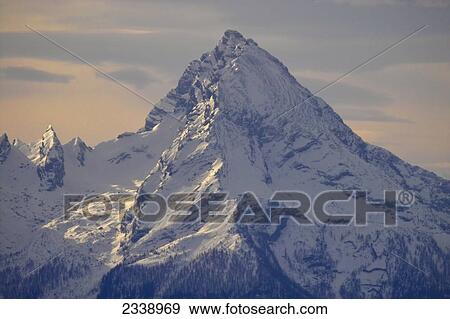 Snowcovered mountain under sky, Austria View Large Photo Image Stock Photo - Snowcovered mountain under sky, Austria . Fotosearch