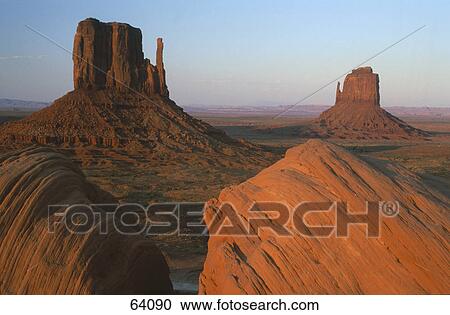 Stock Image - Steep sandstone hills in valley, Merricks Butte, Mitten Butte, Monument Valley, Utah, USA . Fotosearch