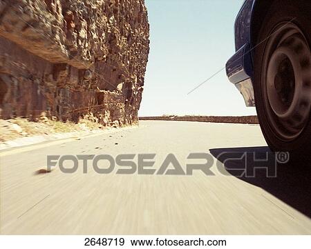 Stock Photo - SUV moving in desert, Chapman's Peak, Cape Peninsula, Cape Town, South Africa . Fotosearch