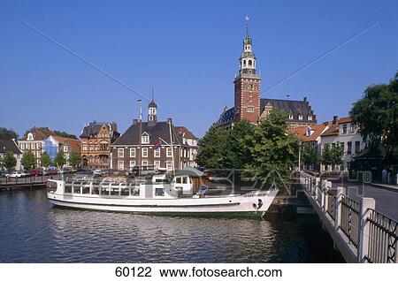 Stock Image - Tour boat in river near bridge, Leer, Lower Saxony, Germany . Fotosearch