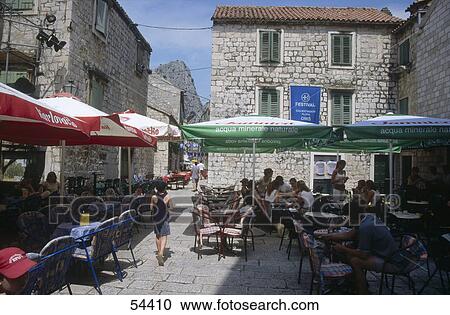 Stock Image - Tourist at outdoor cafe, Omis, Croatia . Fotosearch