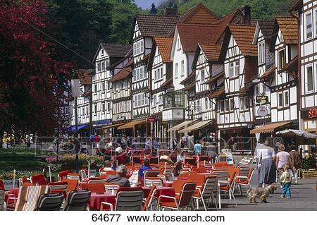 Tourists relaxing on chairs at sidewalk cafe, Hesse, Germany View Large Photo Image Stock Photo - Tourists relaxing on chairs at sidewalk cafe, Hesse, Germany . Fotosearch