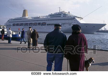 Tourists standing at harbor near cruise ship View Large Photo Image Stock Photo - Tourists standing at harbor near cruise ship . Fotosearch