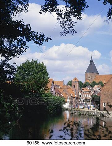 Tree and houses reflected in lake water, St Nikolai Church, Molln, Schleswig-Holstein, Germany View Large Photo Image Stock Photograph - Tree and houses reflected in lake water, St Nikolai Church, Molln, Schleswig-Holstein, Germany . Fotosearch