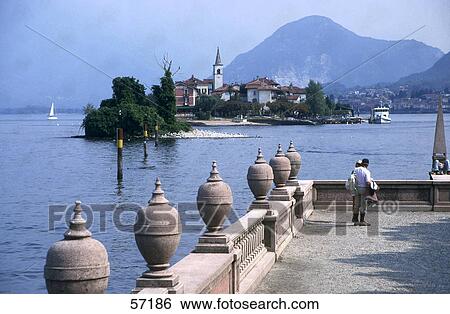 Two people on the balcony overlooking the sea, Lake Maggiore, Piedmont, Italy View Large Photo Image Stock Photograph - Two people on the balcony overlooking the sea, Lake Maggiore, Piedmont, Italy . Fotosearch