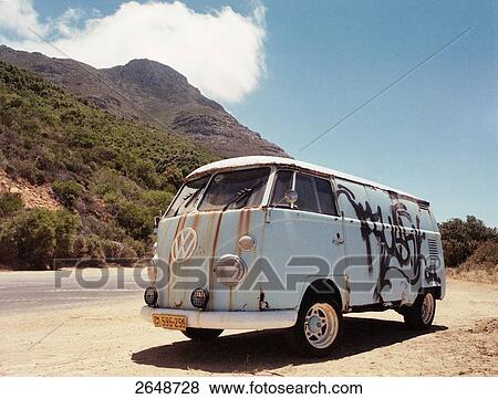 Stock Photo - Volkswagen bus moving in desert, Chapman's Peak, Cape Peninsula, Cape Town, South Africa . Fotosearch