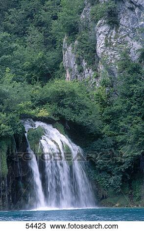 Stock Image - Waterfall cascading in a forest, Croatia . Fotosearch
