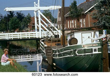 Woman sitting along fishing boat View Large Photo Image Stock Image - Woman sitting along fishing boat . Fotosearch
