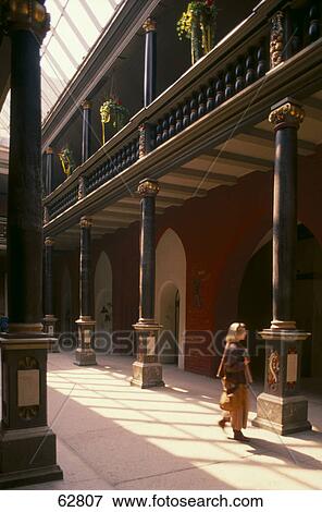 Stock Photo - Woman walking inside building, Stralsund, Germany . Fotosearch