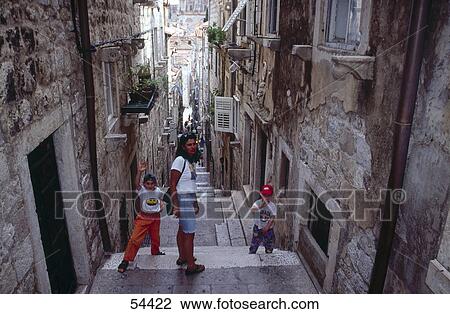 Woman with two children in alley, Dubrovnik, Croatia View Large Photo Image Stock Image - Woman with two children in alley, Dubrovnik, Croatia . Fotosearch