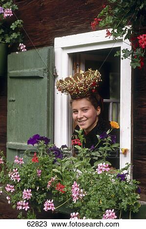 Young woman looking through window and smiling View Large Photo Image Stock Image - Young woman looking through window and smiling . Fotosearch