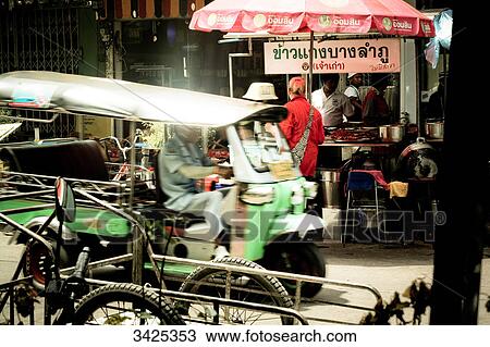 Stock Image - Auto rickshaw in front of a snack bar, Bangkok, Thailand . Fotosearch