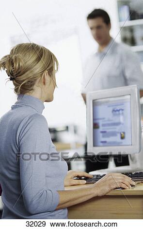 blonde woman woking with a computer, back view View Large Photo Image Stock Photo - blonde woman woking with a computer, back view . Fotosearch