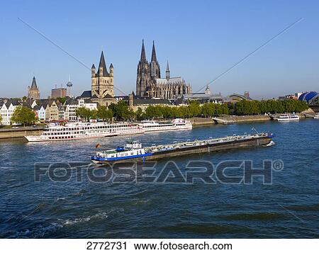 Stock Image - Boat sailing in river, Rhine River, Cologne, Germany . Fotosearch