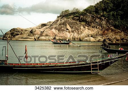Stock Image - Boats at the beach of Ko Phangan, Thailand . Fotosearch