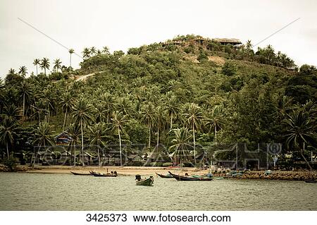 Stock Image - Boats at the coast of Ko Phangan, Thailand . Fotosearch