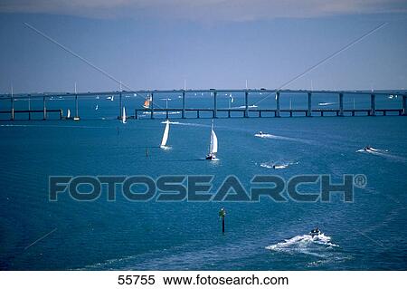 Stock Photography - Boats in sea with bridge in background, Biscayne Bay, Miami, Florida, USA . Fotosearch