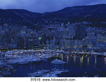 Stock Photograph - Boats moored at harbor during night, Monte Carlo, Monaco, France . Fotosearch