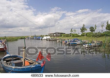 Stock Image - Boats moored in river, Mecklenburg-Vorpommern, Germany . Fotosearch
