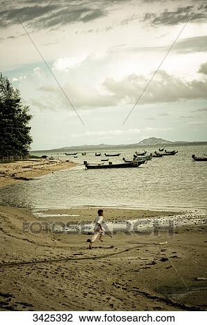 Boy running on the beach, Ko Phangan, Thailand, elevated view View Large Photo Image Stock Image - Boy running on the beach, Ko Phangan, Thailand, elevated view . Fotosearch
