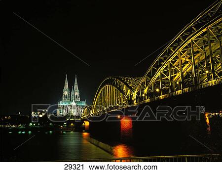 Stock Image - Bridge across river with cathedral in background, Rhein River, Cologne Cathedral, Cologne, Germany . Fotosearch