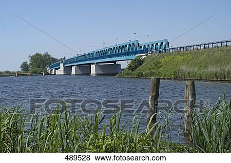 Stock Photo - Bridge over river, Peene River, Mecklenburg-Vorpommern, Germany . Fotosearch