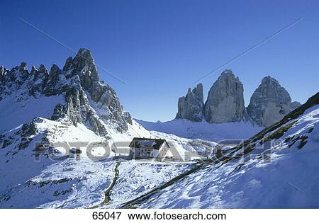Stock Photo - Building on a snowcovered landscape, Tre Cime de Lavaredo, Dolomites, Italy . Fotosearch