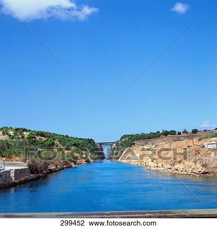 Stock Image - Canal flowing through cliffs, Corinthian Canal, Isthmos, Corinth, Greece . Fotosearch