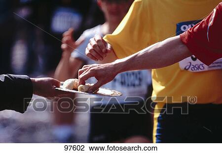 Close-up of a jogger picking a snack while running View Large Photo Image Stock Image - Close-up of a jogger picking a snack while running . Fotosearch