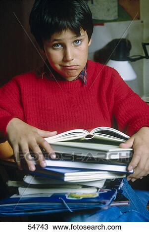 Close-up of boy carrying books and looking sad View Large Photo Image Stock Image - Close-up of boy carrying books and looking sad . Fotosearch