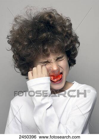 Stock Photograph - Close-up of boy with burst bubble gum bubble on his face . Fotosearch