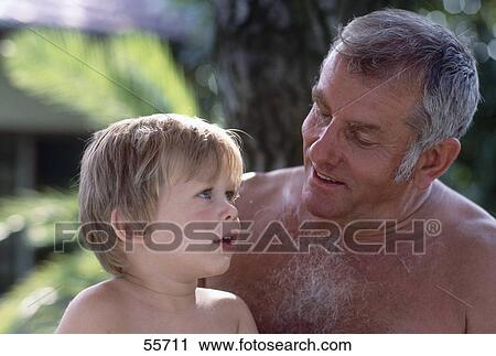 Stock Image - Close-up of grandfather with his grandson . Fotosearch