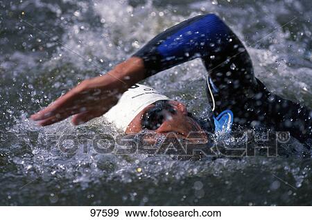 Stock Photo - Close-up of male swimmer swimming in swimming pool . Fotosearch