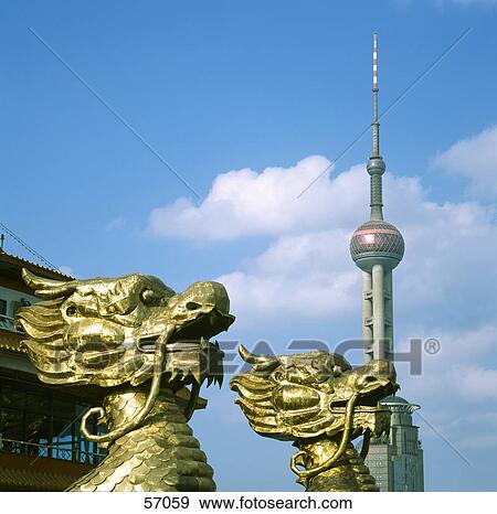 Stock Photo - Close-up of statues in front of communications tower, Shanghai, China, Asia . Fotosearch